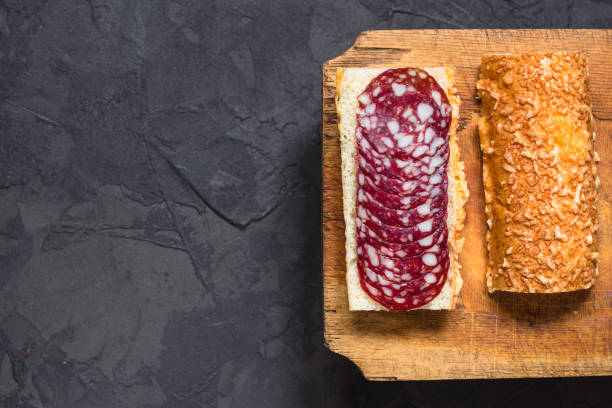 istock sandwich with sausage and baguette bread  (bun with cheese). place for text. copy space 1069738294
