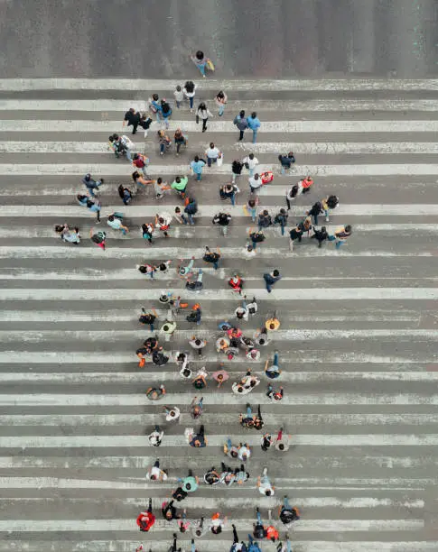 Photo of High Angle View Of People forming and arrow on the street