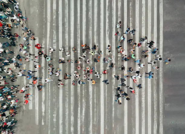 Photo of High Angle View Of People forming and arrow on the street