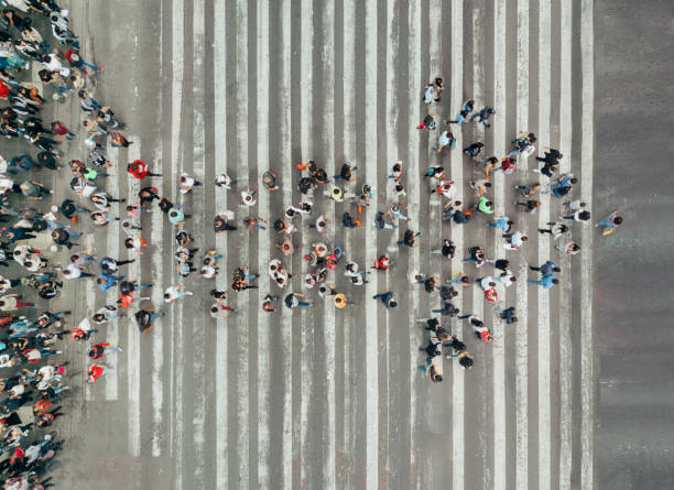 high angle view of people forming and arrow on the street - conceptual vision imagens e fotografias de stock