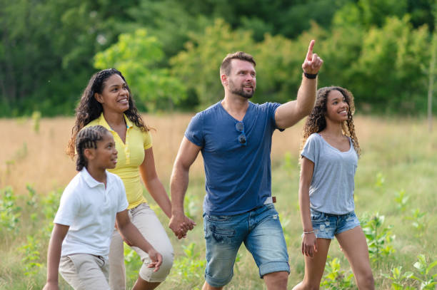 istock Mixed race family walking in the park 1069740200