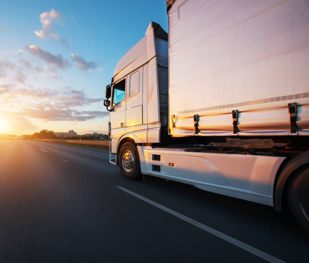 loaded european truck on motorway in sunset - semi truck cargo container mode of transport horizontal imagens e fotografias de stock