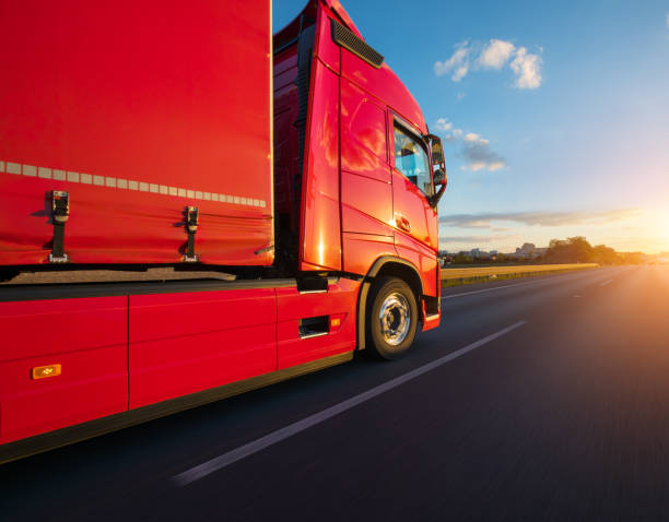 istock Loaded European truck on motorway in sunset 1069743036