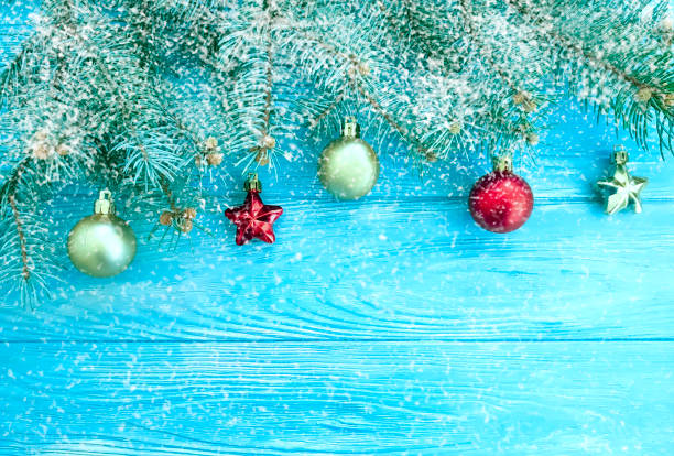 istock Christmas tree branch, wooden background, snow 1069747220