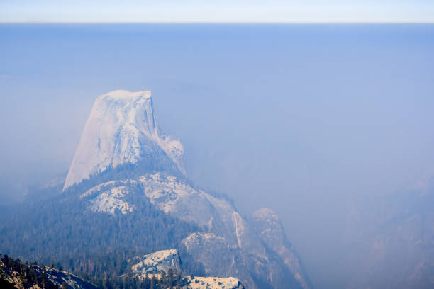 View towards Half Dome and the valley beyond on a day with low visibility due to the smoke coming from the Ferguson Fire, Yosemite National Park, California
