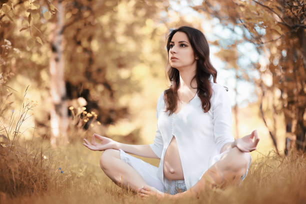 istock Pregnant woman doing yoga exercise in autumn 1069750148
