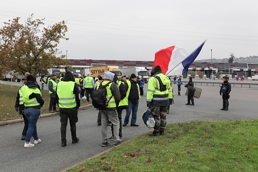 Villefranche en Beaujolais, France - November 19, 2018: Yellow vests protest against higher fuel prices and block motorway in Villefranche en Beaujolais, France