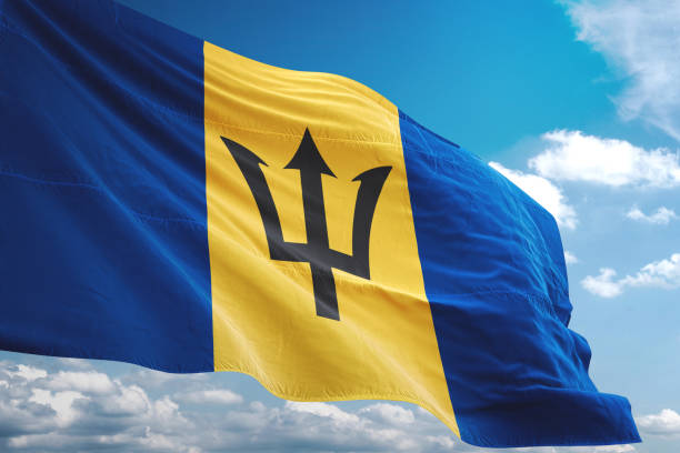 istock Barbados flag waving cloudy sky background 1069750668