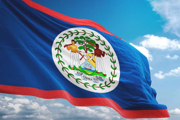 bandiera del belize che sventola sfondo cielo nuvoloso - flag of belize foto e immagini stock