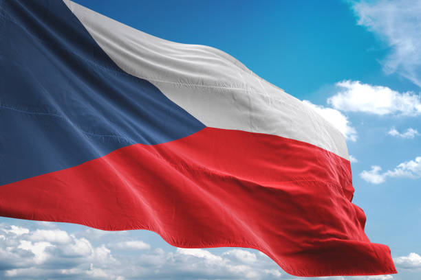 istock Czech Republic flag waving cloudy sky background 1069752142