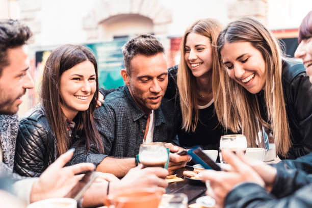 istock Group of friends using smart phones during breakfast outdoor 1069753474