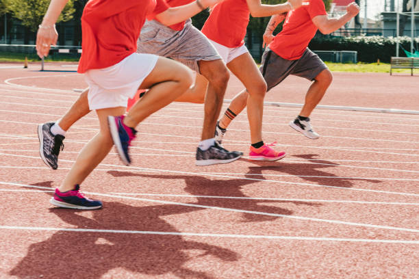 istock Low section view of runner's feet running on racing track 1069753632
