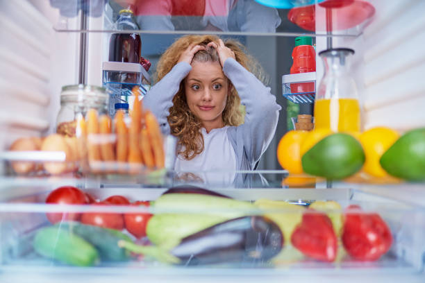 istock Confused woman choosing what to eat. 1069753904