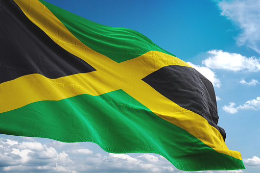 Jamaica flag waving cloudy sky background realistic 3d illustration