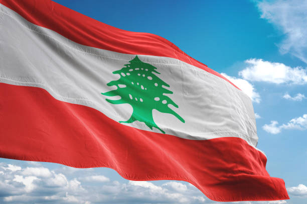 istock Lebanon flag waving cloudy sky background 1069756250