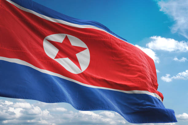 istock North Korea flag waving cloudy sky background 1069756728