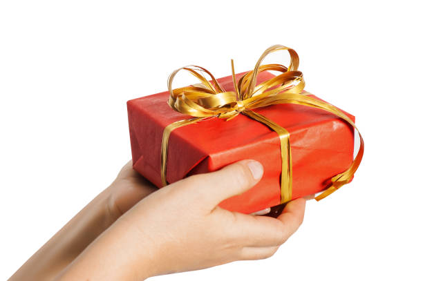 istock Red christmas present with golden bow in woman hands 1069756832