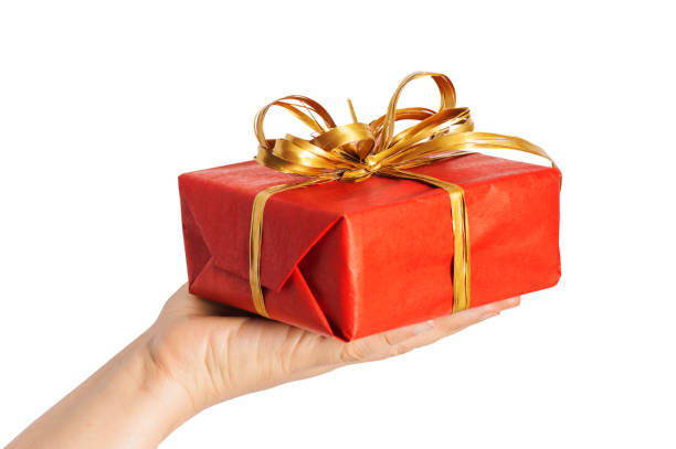 istock Red christmas present with golden bow in woman hands 1069756914
