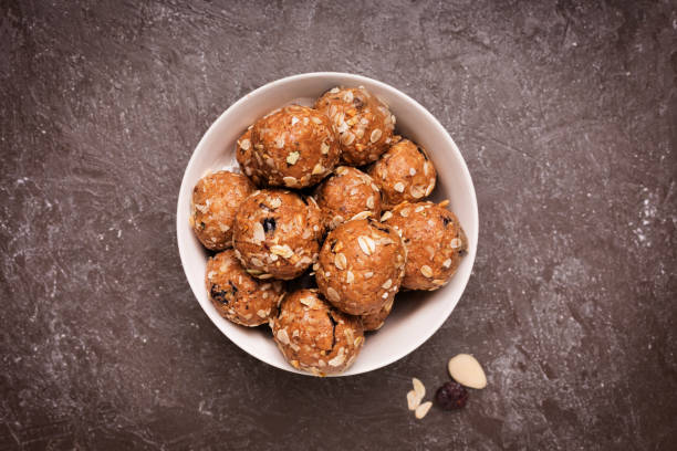 Healthy organic energy granola bolls with nuts, cacao, oats and raisins - vegetarian sweet bites without sugar stock photo