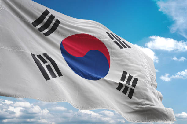istock South Korea flag waving cloudy sky background 1069757932