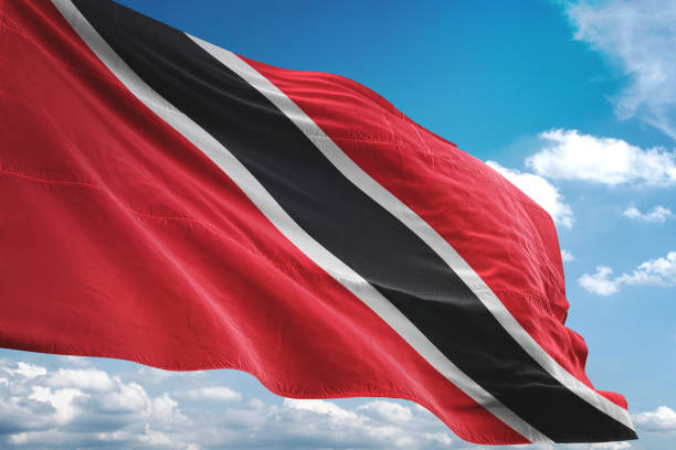 istock Trinidad and Tobago flag waving cloudy sky background 1069758040