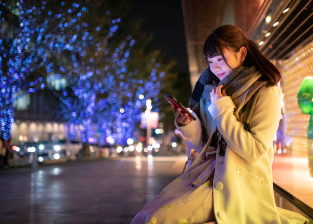 istock Young woman waiting for someone at Christmas night 1069761122