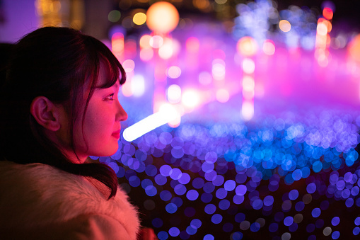 Young woman watching Christmas illumination