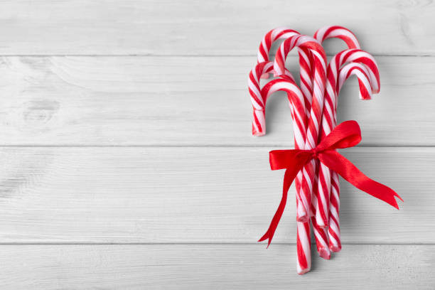 istock Christmas candy canes on a white wooden table 1069764202