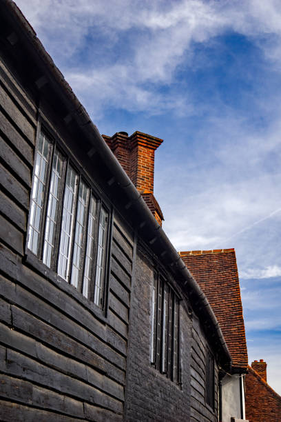 The morning sun warms a red brick chimney of a home in Colonial Williamsburg.