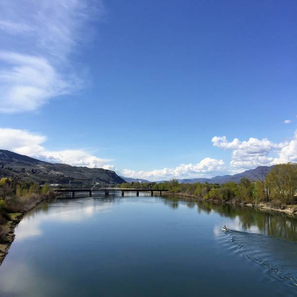 istock Bridge cross the North Thompson River, in Kamloops, British Columbia, Canada.  Beautiful reflection of the clouds, sky, and mountain in the river. 1069771634