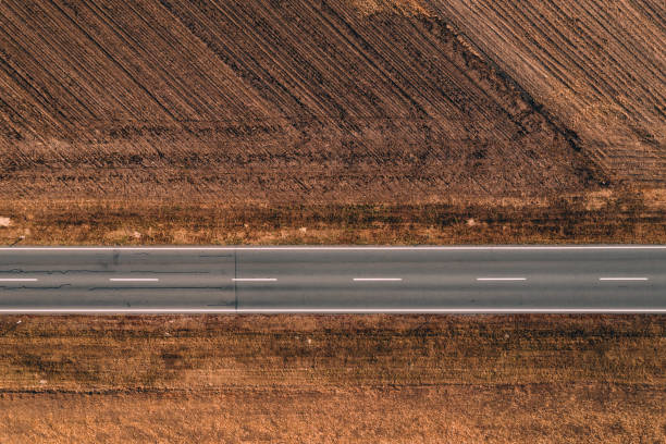 istock Aerial view of empty road through countryside 1069775670