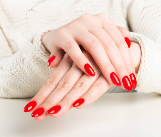 istock young woman with red manicure on nails 1069776340