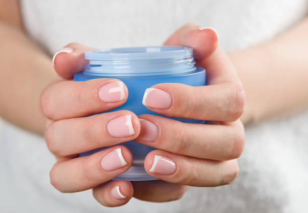 istock beautiful woman hands with cream 1069776398