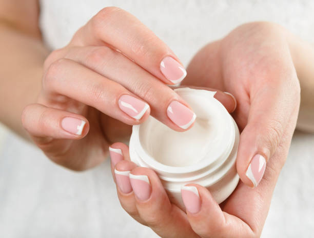 istock beautiful woman hands with cream 1069776404