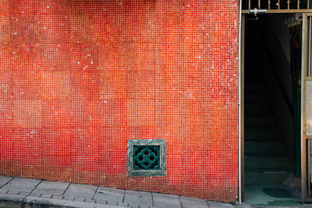 Old red tile wall and open door in Hong Kong