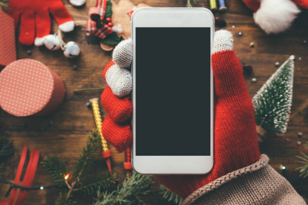 istock Smartphone in hand for Christmas season mock up 1069778716