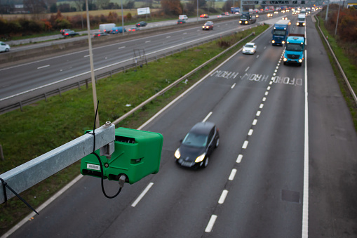 WATFORD, UK - NOVEMBER 15, 2018: Green Highway England ANPR camera monitoring traffic flow on British motorway M1