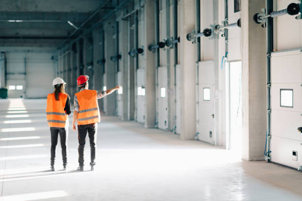 istock Rear View Of Architect Discussing With Coworker At Site 1069779648