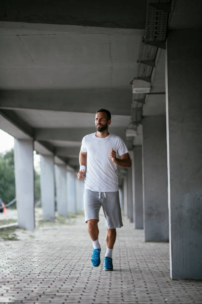 istock Young sportsman running outdoors 1069786436