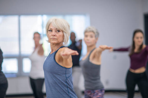 istock Senior woman doing yoga pose 1069788200