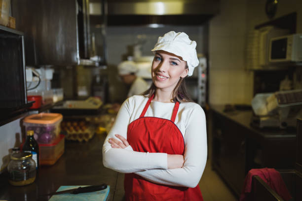 istock Young woman working in the restaurant kitchen 1069789144