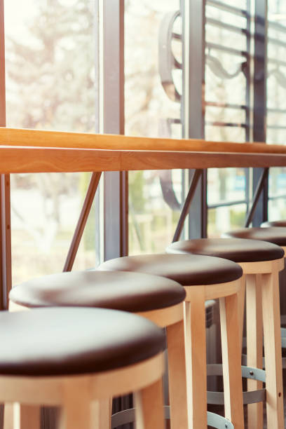 istock Bar stools stand in a row along the window in a cafe 1069791264