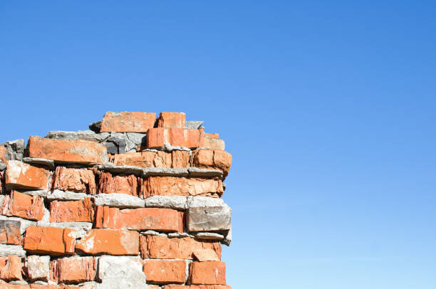 istock part of a crumbling brick wall against a clear blue sky 1069791346