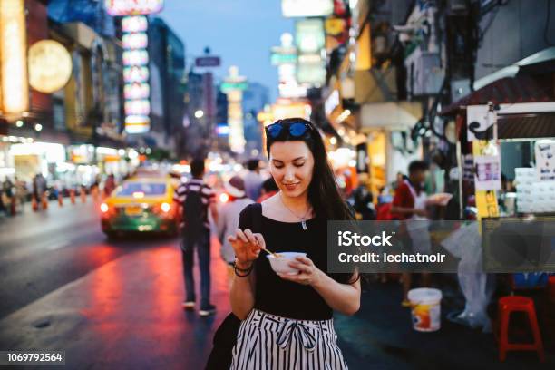 Young Woman Eating Shrimp Tempura In Bangkok Chinatown District Thailand Stock Photo - Download Image Now