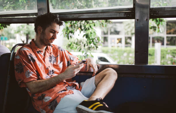 istock Man texting on a cellphone in a public bus in Bangkok, Thailand 1069792778