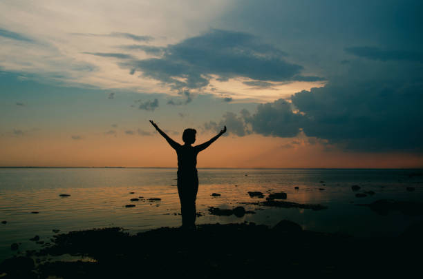 istock female silhouette at sunset 1069798658