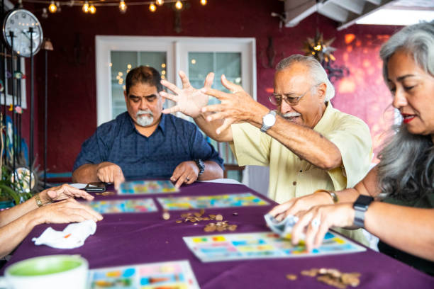 Mexican Family Playing A Game after Dinner A mexican family playing a game after dinner. family playing card game stock pictures, royalty-free photos & images