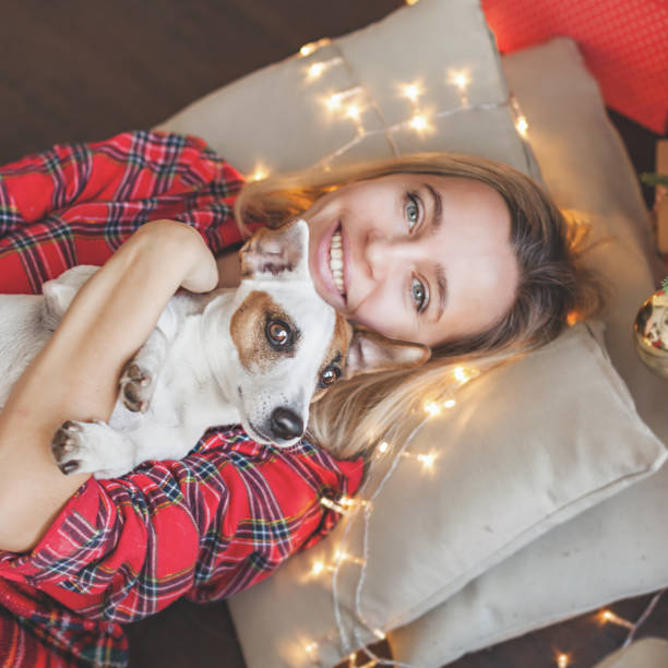 istock Happy woman on Christmas tree background 1069800050