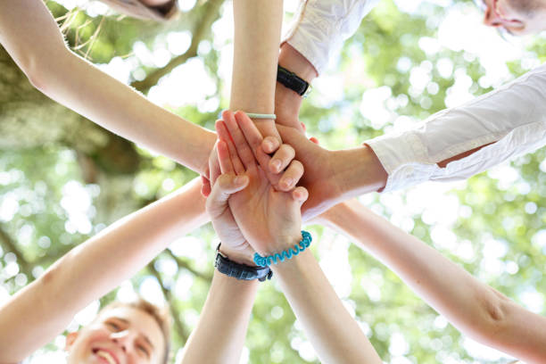 istock Teenagers joined their hands in a circle 1069800088