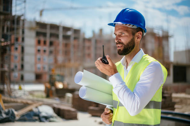 istock Young male architect with walkie-talkie 1069800366